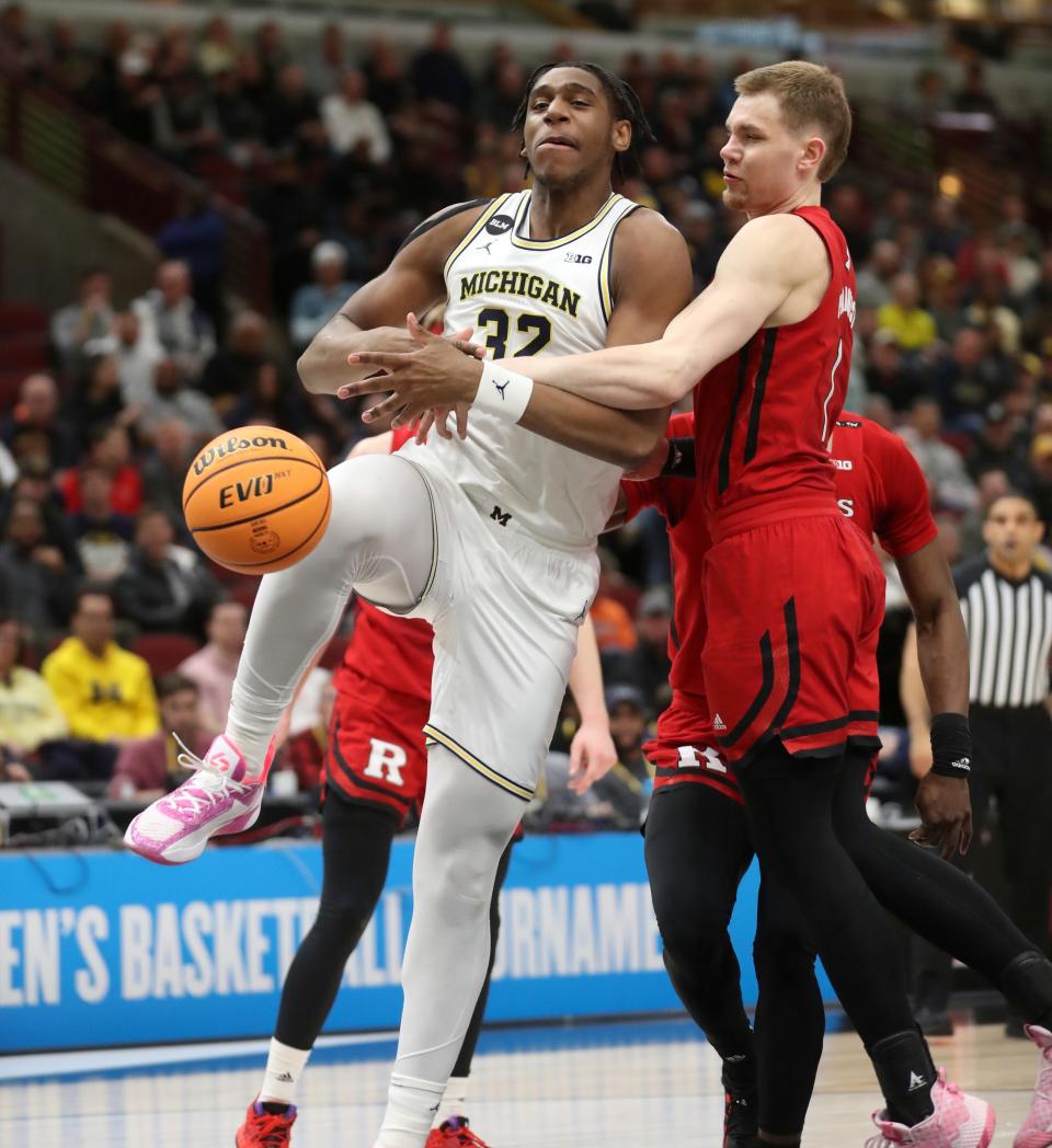 Michigan Wolverines forward Tarris Reed Jr. (32) drives against Rutgers Scarlet Knights forward Oskar Palmquist (1) during first-half action in the Big Ten tournament at United Center in Chicago on Thursday, March 9, 2023.