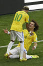 Brazil's David Luiz, right, celebrates with his teammate Neymar after Brazil scored the opening goal during the World Cup round of 16 soccer match between Brazil and Chile at the Mineirao Stadium in Belo Horizonte, Brazil, Saturday, June 28, 2014. (AP Photo/Hassan Ammar)