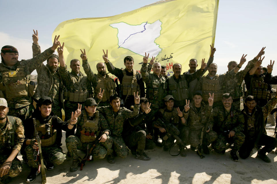 U.S.-backed Syrian Democratic Forces (SDF) fighters pose for a photo on a rooftop overlooking Baghouz, Syria, after the SDF declared the area free of Islamic State militants after months of fighting last March. (Photo: Maya Alleruzzo/AP) 