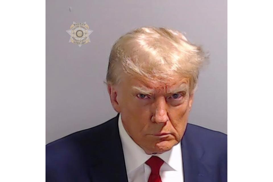 This booking photo provided by Fulton County Sheriff's Office, shows former President Donald Trump on Thursday, Aug. 24, 2023, after he surrendered and was booked at the Fulton County Jail in Atlanta. Trump is accused by District Attorney Fani Willis of scheming to subvert the will of Georgia voters in a desperate bid to keep Joe Biden out of the White House. (Fulton County Sheriff's Office via AP)