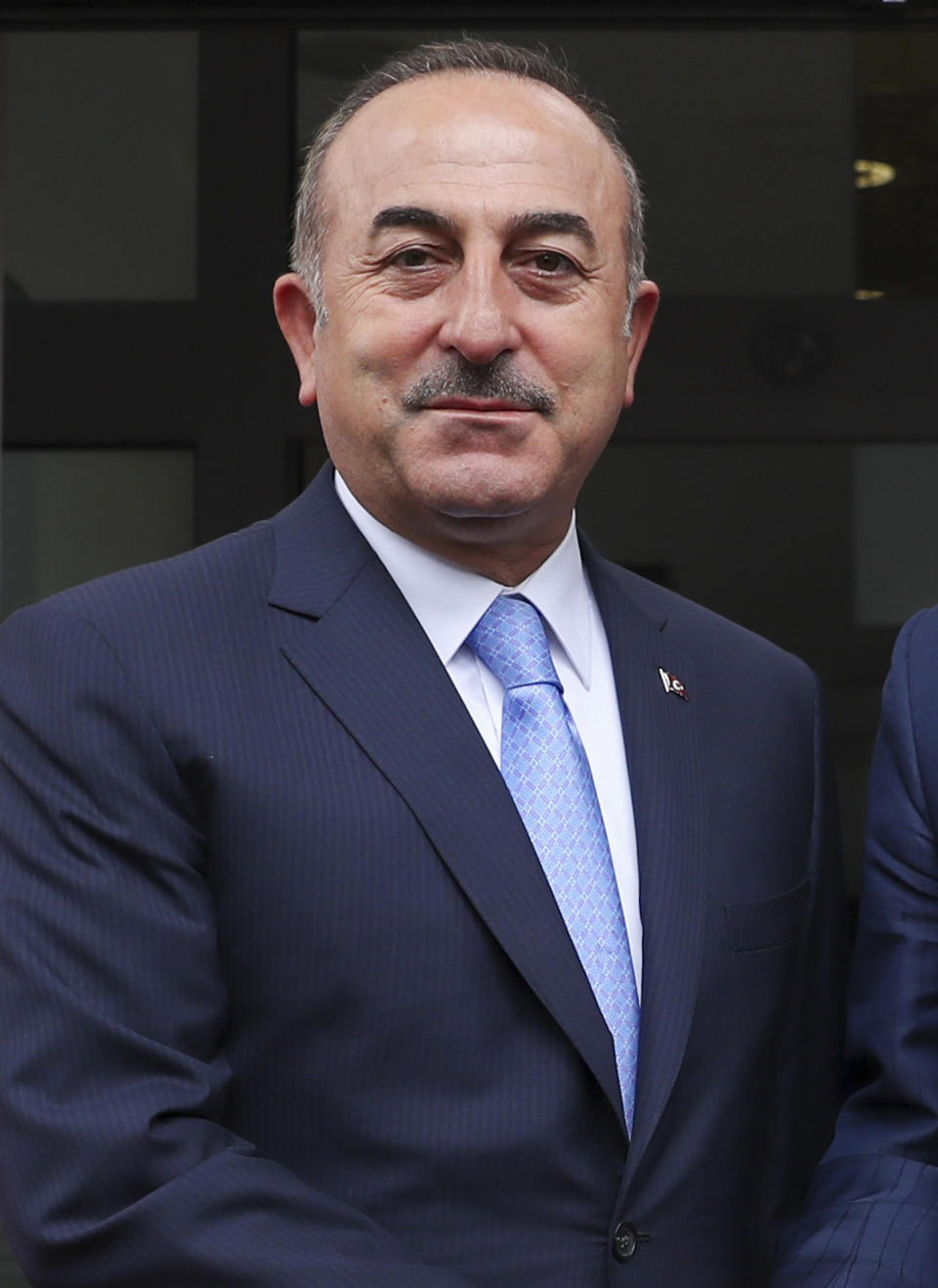 Turkey's Foreign Minister Mevlut Cavusoglu, left, poses for photographs prior to his meeting with North Macedonia's Foreign Minister Nikola Dimitrov, in Skopje, North Macedonia, Tuesday, July 16, 2019. Cavusoglu on Tuesday downplayed as "worthless" an initial set of sanctions approved by the European Union against Ankara and vowed to send a new vessel to the eastern Mediterranean to reinforce its efforts to drill for hydrocarbons off the island of Cyprus. EU foreign ministers on Monday approved sanctions against Turkey over its drilling for gas in waters where EU member Cyprus has exclusive economic rights. (Cem Ozdel/Turkish Foreign Ministry via AP, Pool)