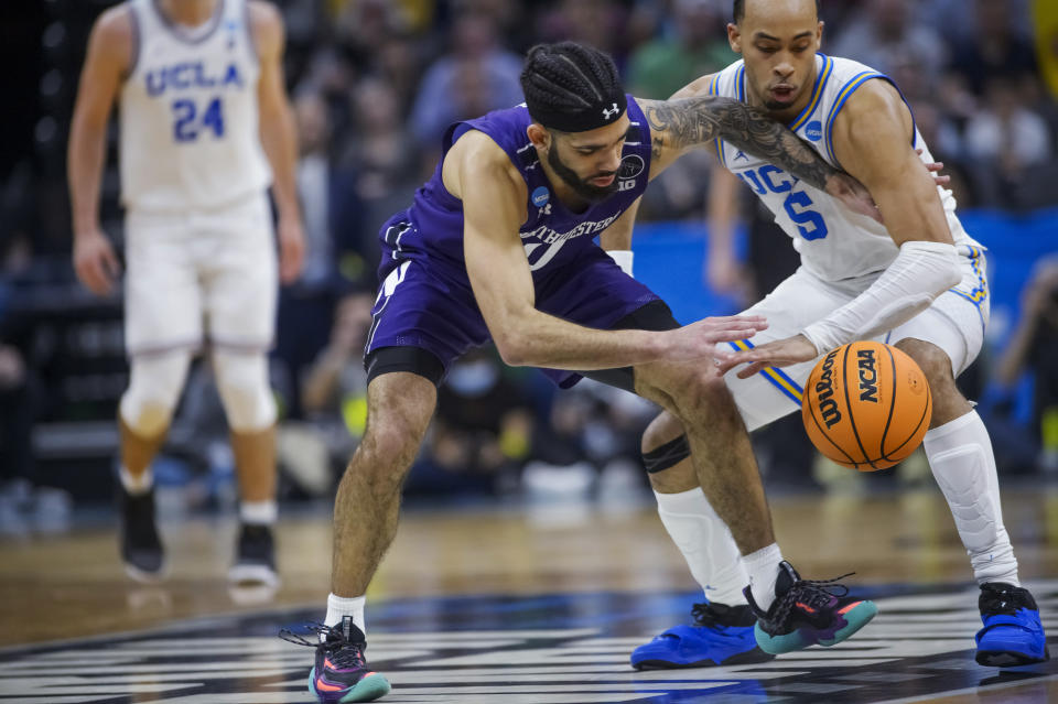 Northwestern guard Boo Buie, left, and UCLA guard Amari Bailey try to get possession of the ball during the second half of a second-round college basketball game in the men's NCAA Tournament in Sacramento, Calif., Saturday, March 18, 2023. UCLA won 68-63. (AP Photo/Randall Benton)