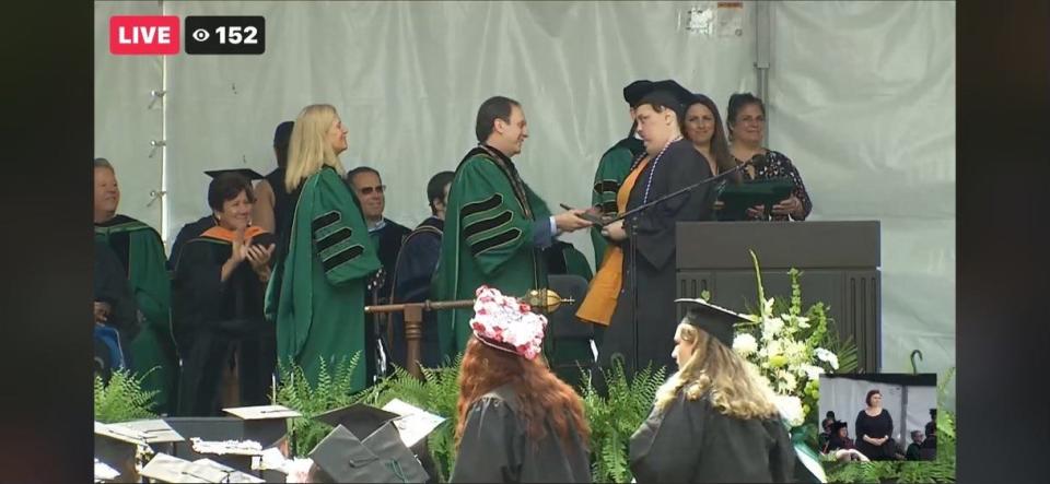 McKenzy Hupke at Wagner College's graduation, receiving her diploma from college president Angelo Araimo.