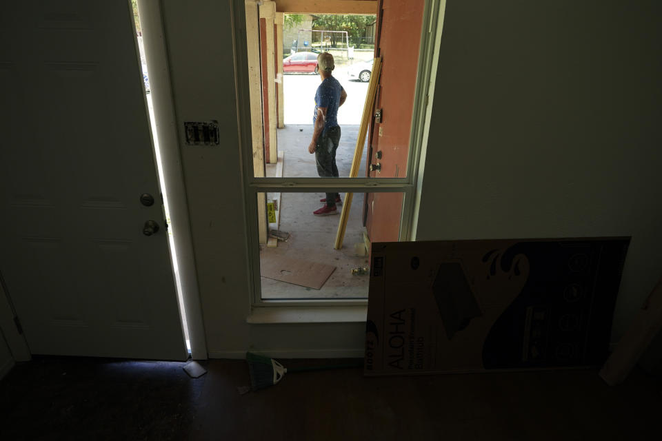 A rafter from Cuba who recently arrived in Miami illegally by sea, seeking to escape political and economic difficulties, is seen at a worksite, Wednesday, July 6, 2022, in Austin, Texas. (AP Photo/Eric Gay)