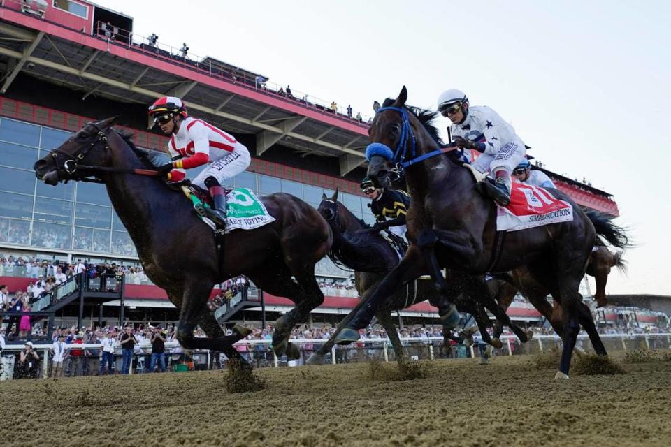 Jose Ortiz atop Early Voting, left, and John Velazquez aboard Simplification, right, compete in the 147th running of the Preakness Stakes at Pimlico Race Course on Saturday in Baltimore.