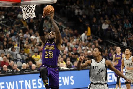 Dec 7, 2018; San Antonio, TX, USA; Los Angeles Lakers small forward LeBron James (23) dunks the ball past San Antonio Spurs shooting guard DeMar DeRozan (10) during the second half at AT&T Center. Soobum Im-USA TODAY Sports