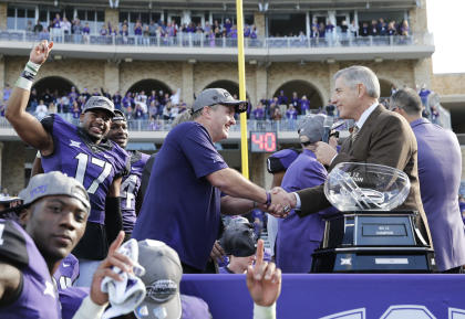 Big 12 commish Bob Bowlsby (R) hands the Big 12 trophy to TCU's Gary Patterson on Saturday. (USAT)