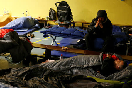 Migrants sleep in a gym opened by Red Cross volunteers after a big fire destroyed many wood houses at a camp for migrants in Grande-Synthe near Dunkirk, France, April 11, 2017. REUTERS/Pascal Rossignol