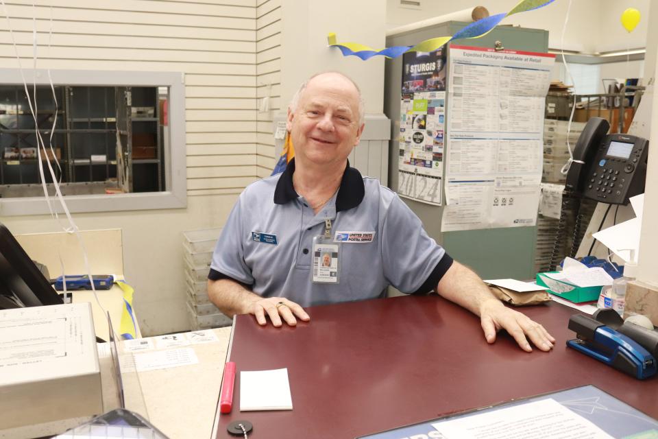 Chris Milligan pauses for a photo Friday between customers. Milligan retires from the Sturgis Post Office April 30 after 38 years of service.