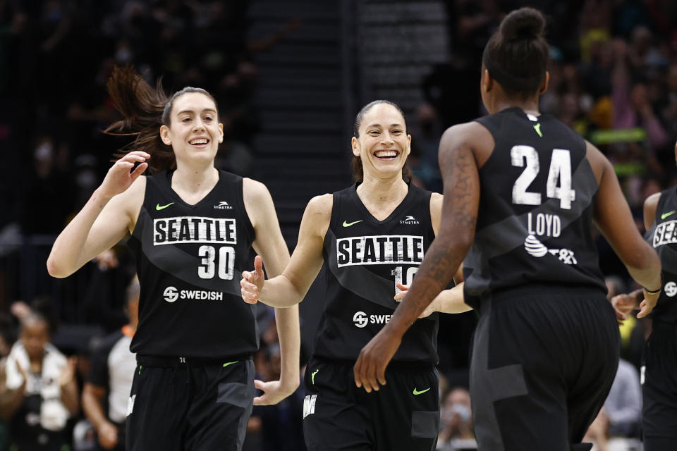 Breanna Stewart and Sue Bird of the Seattle Storm celebrate a 3-pointer by Jewell Loyd against the Las Vegas Aces during the fourth quarter at Climate Pledge Arena in Seattle on June 29, 2022. (Steph Chambers/Getty Images)