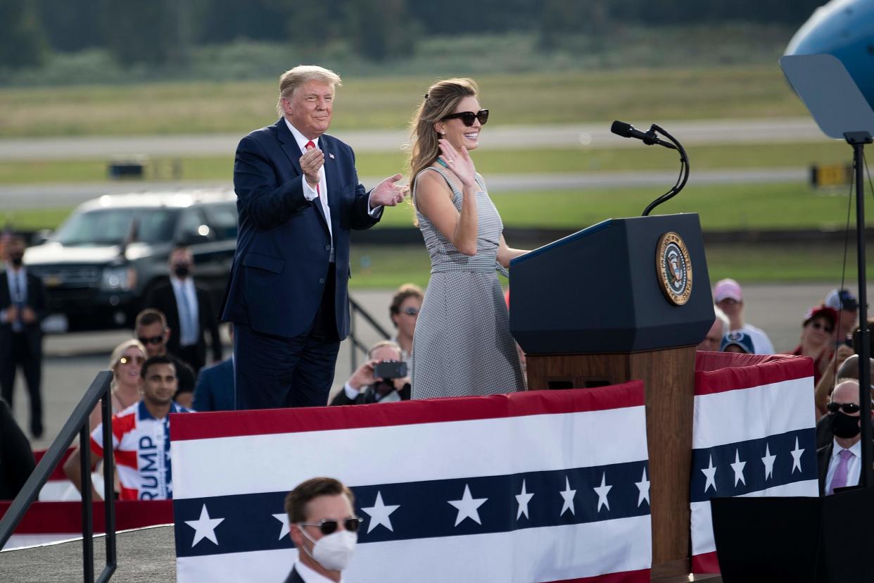 <p>US President Donald Trump listens as aide Hope Hicks speaks during a Make America Great Again rally at Ocala International Airport in Ocala, Florida on October 16, 2020. (Photo by Brendan Smialowski / AFP) </p> ((Photo by BRENDAN SMIALOWSKI/AFP via Getty Images))