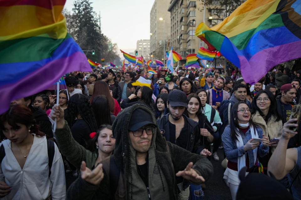 People take part in the Gay Pride parade marking the culmination of LGBTQ+ Pride month, in Santiago, Chile, Saturday, June 29, 2024. (AP Photo/Esteban Felix)