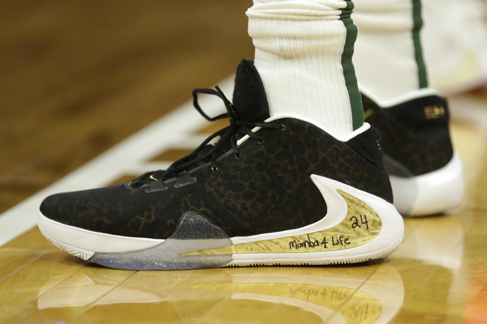 The shoes of Milwaukee Bucks' Giannis Antetokounmpo are seen with a message honoring Kobe Bryant, during the first half of the Bucks' NBA basketball game against the Denver Nuggets on Friday, Jan. 31, 2020, in Milwaukee. (AP Photo/Aaron Gash)