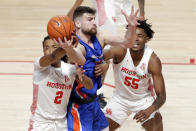 Houston guard Caleb Mills (2) strips a pass away from Boise State forward Mladen Armus, center, as forward Brison Gresham (55) looks on during the first half of an NCAA college basketball game Friday, Nov. 27, 2020, in Houston. (AP Photo/Michael Wyke)