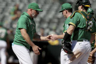 Oakland Athletics' manager Mark Kotsay, left, takes the ball from starting pitcher JP Sears (38) in the fourth inning of a baseball game against the New York Mets in Oakland, Calif., on Sunday, Sept. 25, 2022. (AP Photo/Scot Tucker)