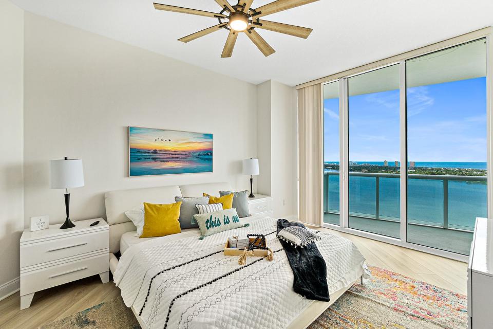 Get comfortable in this primary suite that showcases both ocean and river views along with balcony access, a large walk-in closet and an oversized marble bath.