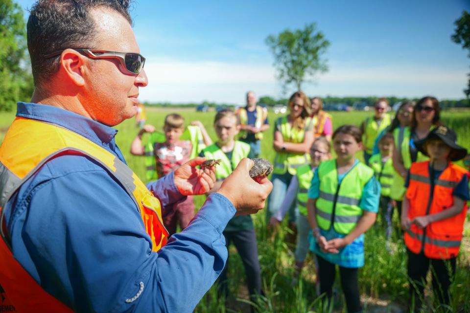 Herpetologist David Mifsud speaks to children as they prepare to release young turtles back into the wild.