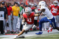 Ohio State receiver Jaxon Smith-Njigba, left, runs out of bounds as Tulsa defensive back TieNeal Martin defends during the first half of an NCAA college football game Saturday, Sept. 18, 2021, in Columbus, Ohio. (AP Photo/Jay LaPrete)