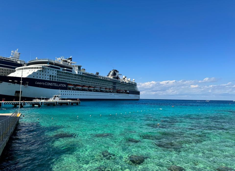 a large cruise ship docked at a port in beautiful blue water