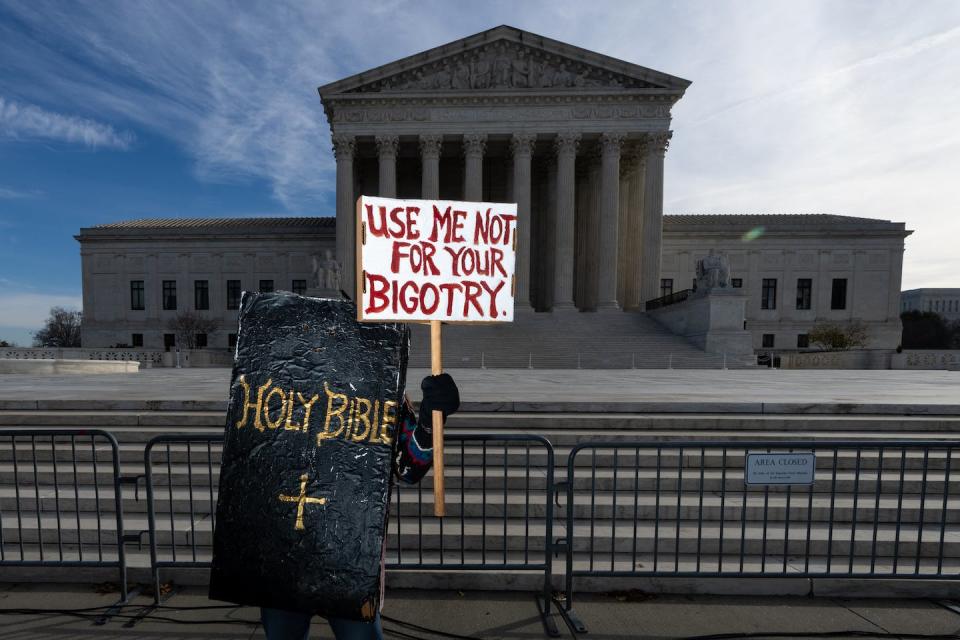 A protester dressed in a Bible costume stands outside the Supreme Court Building during the 303 Creative v. Elenis hearing. <a href="https://media.gettyimages.com/id/1245382361/photo/suprme-court-303-creative-v-elenis.jpg?s=1024x1024&w=gi&k=20&c=F7IIKhMPlGdWCLigmUqtOS2SzItgrWaFyrAeMRPsi9w=" rel="nofollow noopener" target="_blank" data-ylk="slk:Bill Clark/CQ-Roll Call, Inc via Getty Images;elm:context_link;itc:0;sec:content-canvas" class="link ">Bill Clark/CQ-Roll Call, Inc via Getty Images</a>