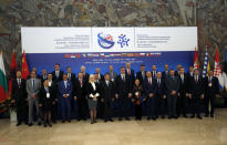 Serbian President Aleksandar Vucic, center front, Chinese Transport Minister Li Xiaopeng and other leaders pose for a family picture during a meeting of China and 16 countries of central and eastern Europe in Belgrade, Serbia, Tuesday, Oct. 16, 2018. The gathering focusing on transport is part of China's "New Silk Road" initiative to increase global influence through economic links and investment. (AP Photo/Darko Vojinovic).