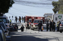 <p>Emergency vehicles are parked and police gather outside a UPS package delivery warehouse where a shooting took place Wednesday, June 14, 2017, in San Francisco. A UPS spokesman says four people were injured in the shooting at the facility and that the shooter was an employee. (AP Photo/Eric Risberg) </p>