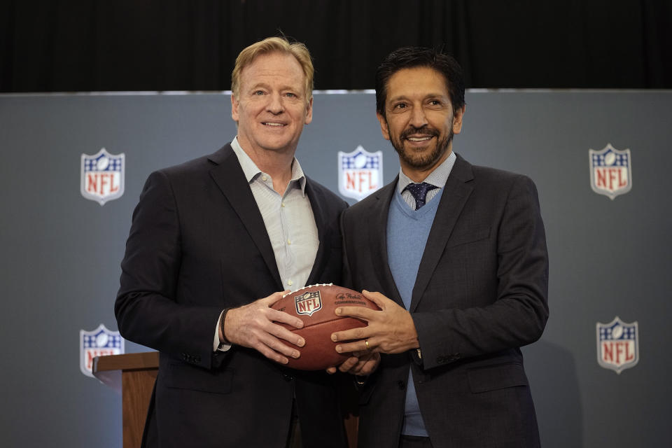 NFL Commisoner Roger Goodell, left, poses with a football with the Mayor of Sao Paulo, Brazil, Ricardo Nunes during a news conference at the NFL owners meeting in Irving, Texas, Wednesday, Dec. 13, 2023. The NFL announced that a regular season game will be played in Sao Paulo. (AP Photo/LM Otero)