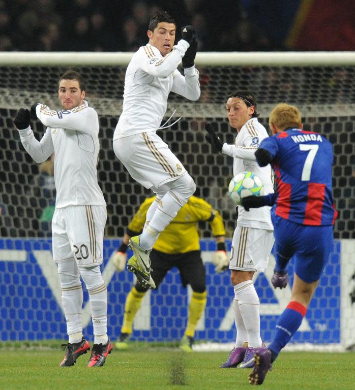 Real Madrid's players, including Cristiano Ronaldo (C) attempt to block a kick by Keisuke Honda of CSKA Moscow, during an UEFA Champions League match in Moscow, on February 21, 2012
