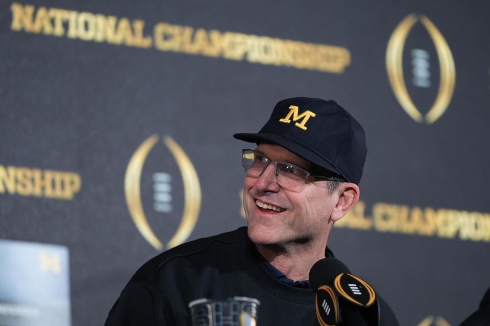 Michigan head coach Jim Harbaugh smiles during an NCAA college football news conference Tuesday, Jan. 9, 2024, in Houston. Harbaugh and No. 1 Michigan completed a three-year climb to a national championship by beating No. 2 Washington 34-13 Monday night in the College Football Playoff title game.(AP Photo/Eric Gay)