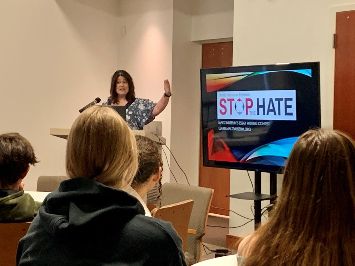 Julie Zorn, director of outreach and education for Temple Israel, presents information on how students can combat hate during the inaugural A Day of Remembrance-A Day Against Hate at Bei Ha’am in Canton.