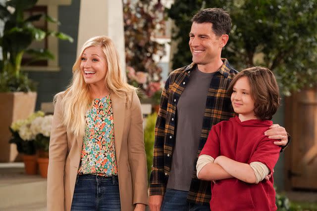 <p>Michael Yarish/CBS</p> Beth Behrs as Gemma Johnson, Max Greenfield as Dave Johnson and Hank Greenspan as Grover Johnson in 'The Neighborhood'.