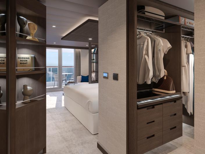A walk in closet next to a bed.