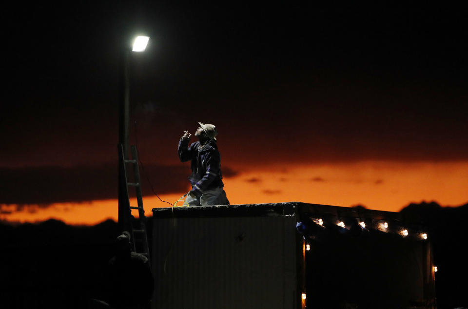 A man sets up a a light in preparation for an event inspired by the "Storm Area 51" internet hoax near the Little A'Le'Inn motel and cafe, Sept. 19, 2019, in Rachel, Nev.  (Photo: John Locher/AP)