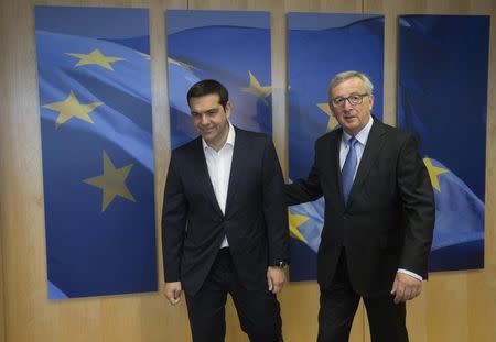Greek Prime Minister Alexis Tsipras (L) walks next to European Commission President Jean-Claude Juncker for a meeting ahead of a Eurozone emergency summit on Greece in Brussels, Belgium June 22, 2015. REUTERS/Olivier Hoslet