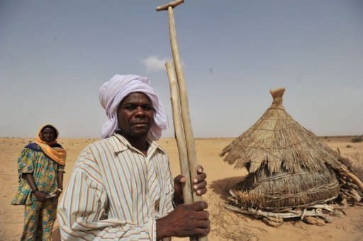 Nigerien farmer Oumarou Hassane and his wife stand in a dried-out field near the southern town of Tanout in the southern Zinder region. In Niger, six million people out of the 18 million in the desert Sahel region of west Africa are threatened with famine each year, according to the United Nations