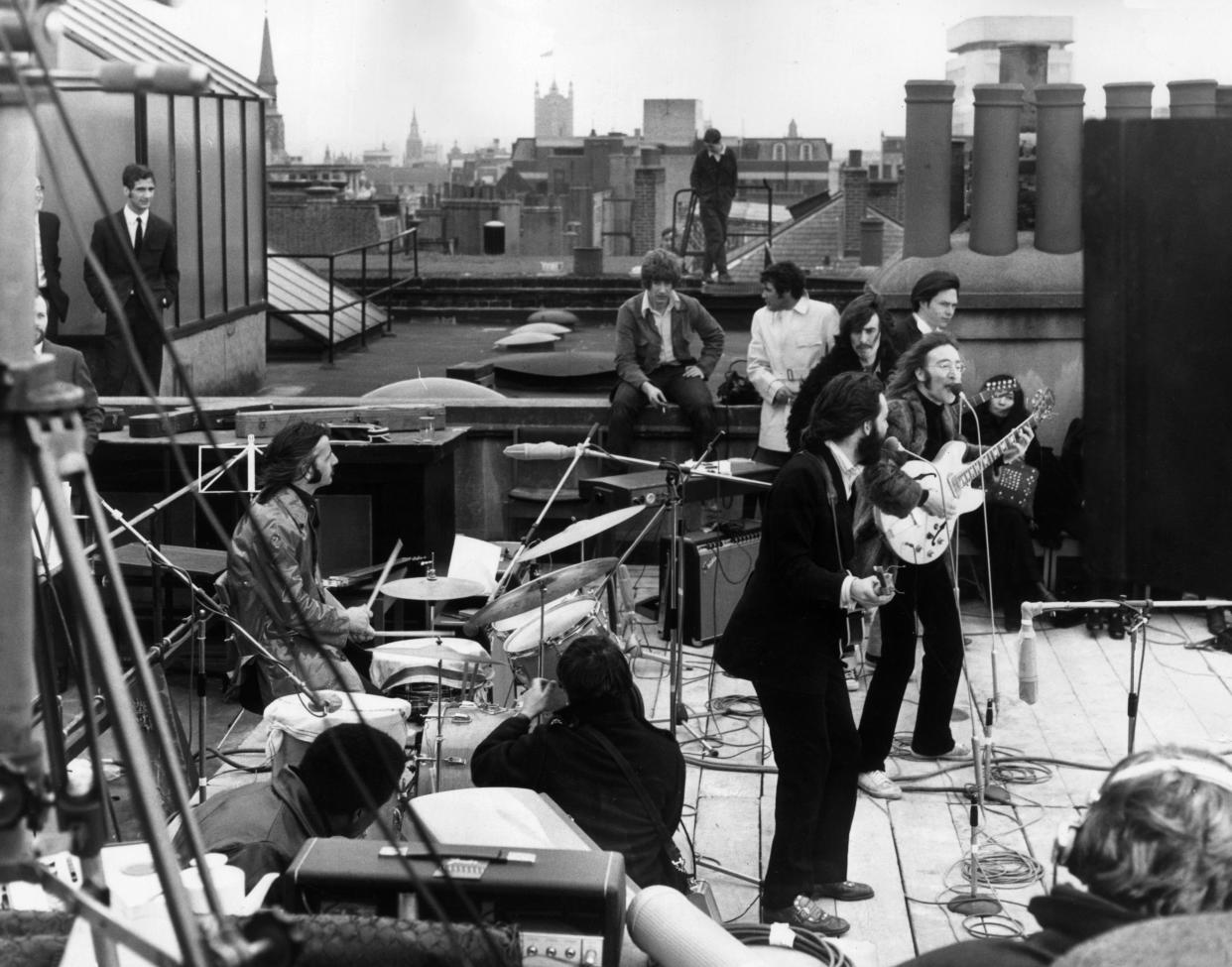 The Beatles performing their last live public concert on the rooftop of the Apple Corps building on Savile Row, London, England. / Credit: Express/Express/Getty Images