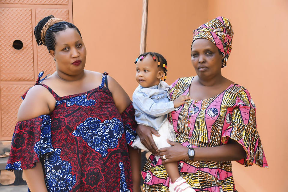 In this undated family photo provided by Sophonie Bizimana, a refugee from Congo, Bizimana's wife, Ziporah Nyirahimbya, right, is shown with their daughter Aline Munezo, and their granddaughter, Liorah Ikaze Bigzi, in Uganda. Despite Bizimana being a permanent U.S. resident, Nyirahimbya has so far been unable to join him in the U.S. For decades, America admitted more refugees annually than all other countries combined, but that reputation has eroded during Donald Trump's presidency as he cut the number of refugees allowed in by more than 80 percent. (Courtesy Sophonie Bizimana via AP)