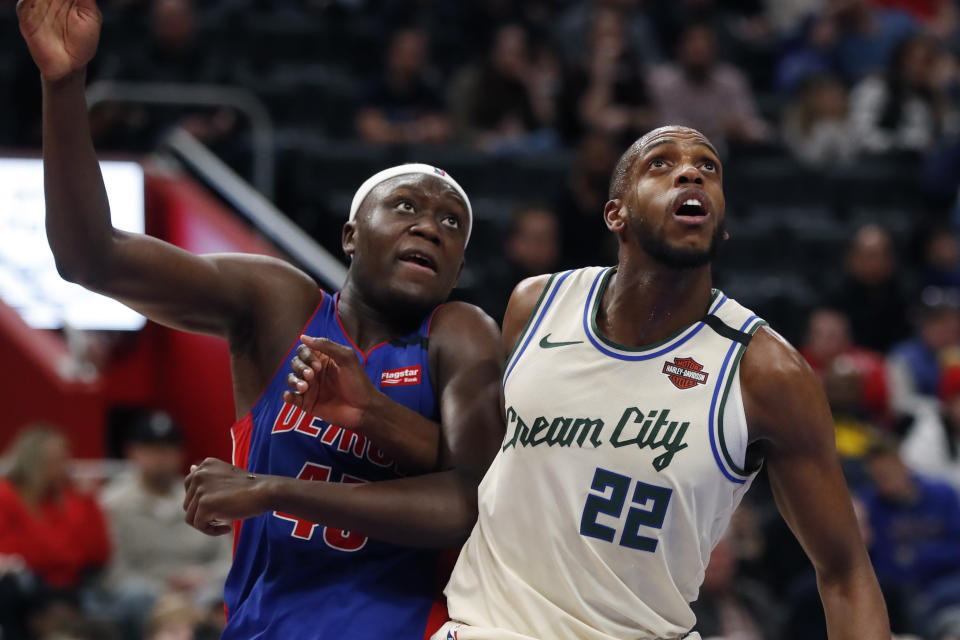 Detroit Pistons forward Sekou Doumbouya (45) and Milwaukee Bucks forward Khris Middleton (22) wait for the rebound during the first half of an NBA basketball game, Thursday, Feb. 20, 2020, in Detroit. (AP Photo/Carlos Osorio)