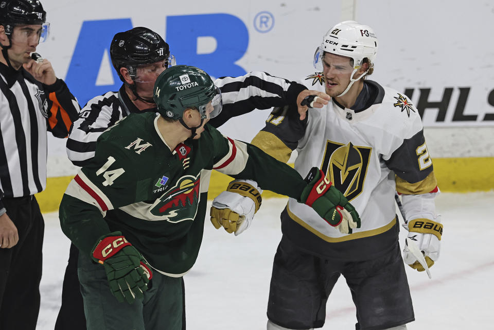 Minnesota Wild center Joel Eriksson Ek (14) argues with Vegas Golden Knights center Brett Howden (21) during the first period of an NHL hockey game Monday, April 3, 2023, in St. Paul, Minn. (AP Photo/Stacy Bengs)