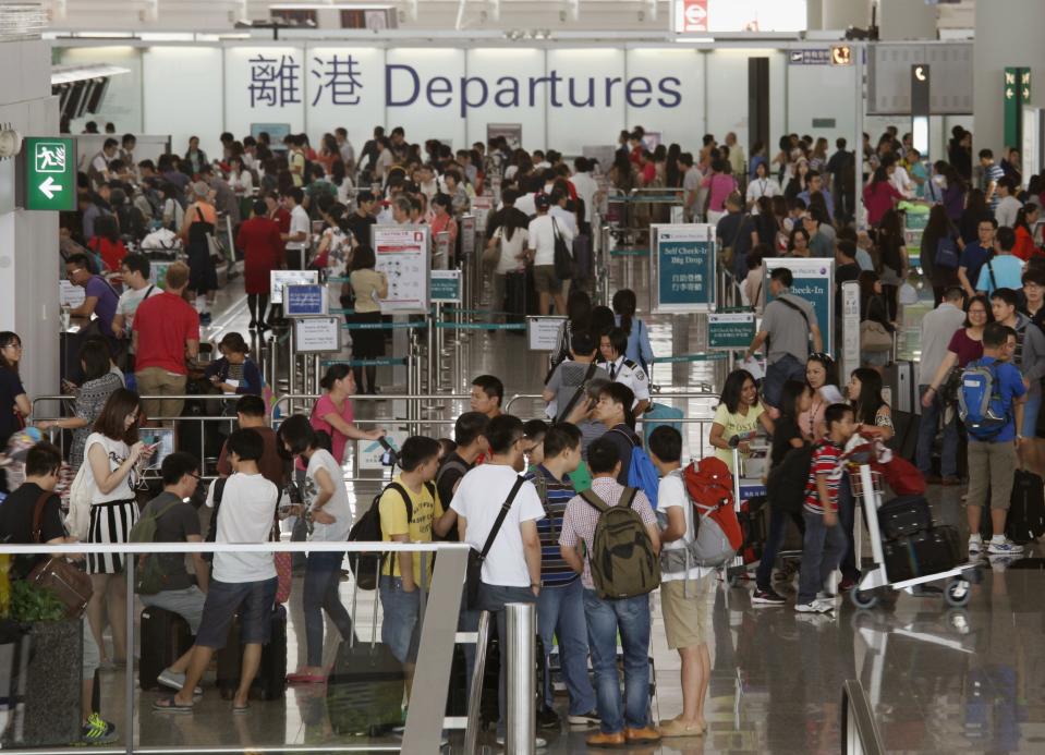 Passengers wait at Hong Kong Airport as flights are cancelled in anticipation of typhoon Usagi, September 22, 2013. Hong Kong was bracing on Sunday for this year's most powerful typhoon, with government meteorologists warning of severe flooding created by a double whammy of powerful winds and exceptionally high tides. Typhoon Usagi, the strongest storm to hit the Western Pacific this year, is expected to hit the Asian financial center late on Sunday and early on Monday. (REUTERS/Bobby Yip)