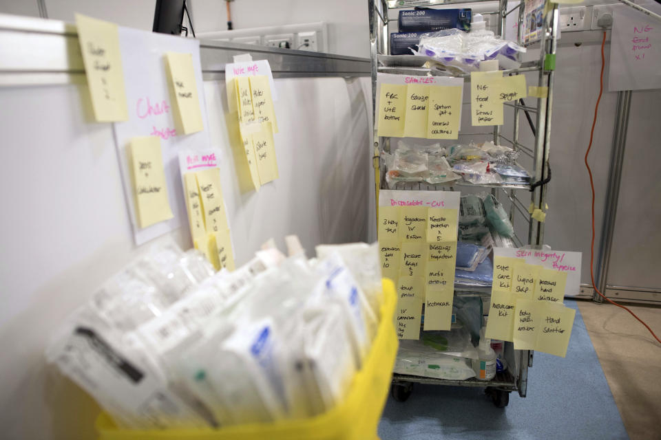 FILE - In this Tuesday, March 31, 2020 photo medical equipment is labelled and prepared for use at the ExCel centre which is being made into a temporary hospital called NHS Nightingale in London. In the fight against the coronavirus pandemic, soldiers are delivering millions of face masks to hospitals and helping to build makeshift medical facilities, including one at London's ExCel convention center that can treat as many as 4,000 patients. (Stefan Rousseau/Pool Photo via AP, File)