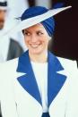 <p>In a blue-and-white Philip Somerville turban hat. </p>