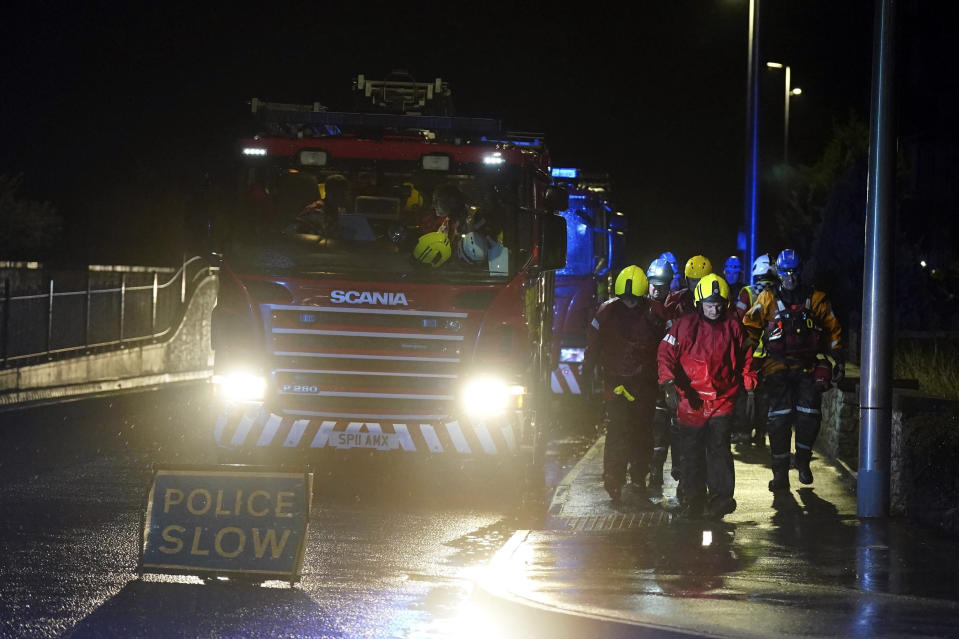 Emergency services in River Street in Stonehaven, Scotland, Thursday, Oct. 19, 2023. Hundreds of people are being evacuated from their homes and schools have closed in parts of Scotland, as much of northern Europe braces for stormy weather, heavy rain and gale-force winds from the east. The U.K.’s weather forecaster, the Met Office, issued a rare red alert, the highest level of weather warning, for parts of Scotland. (Andrew Milligan/PA via AP)