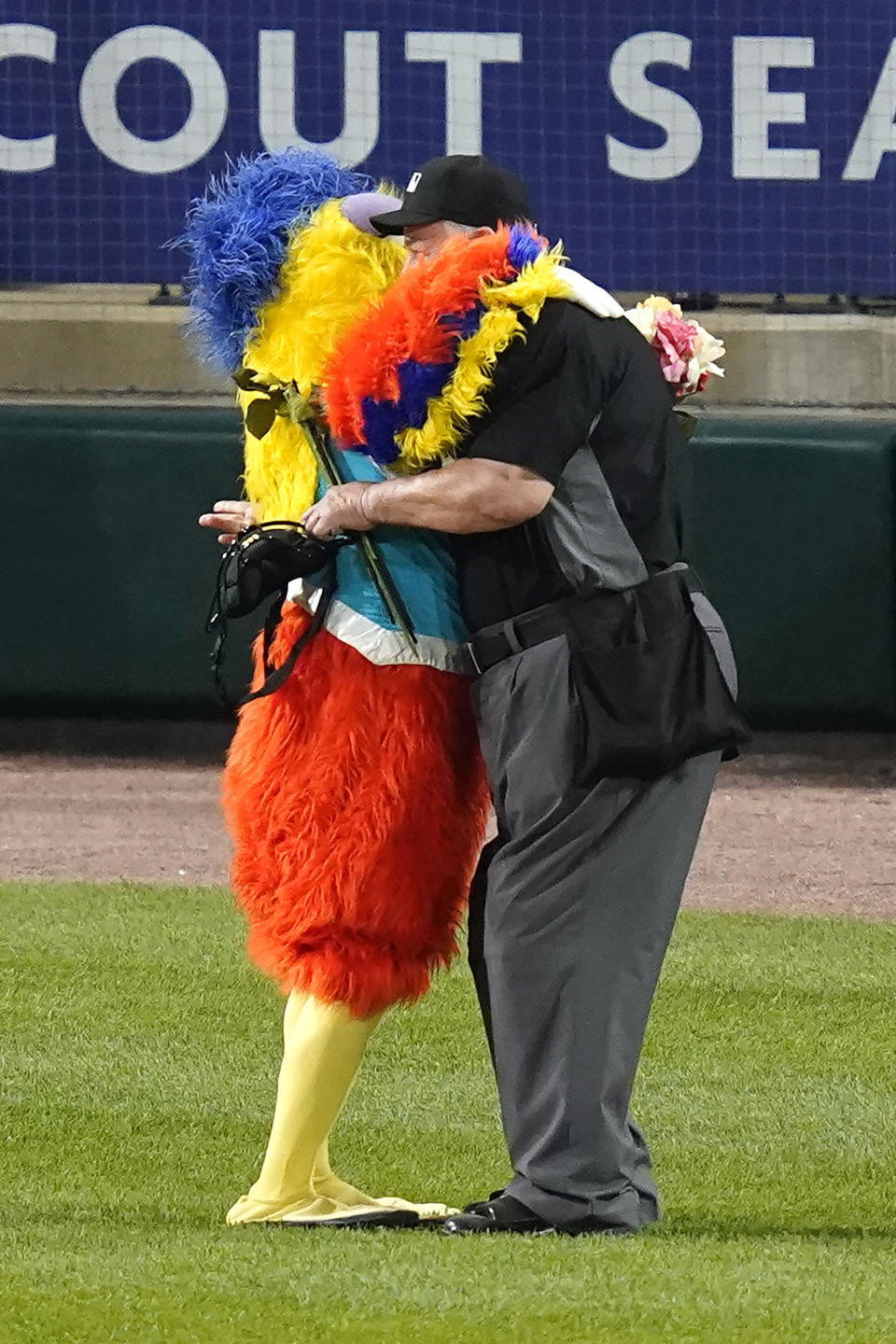 The San Diego Chicken hugs umpire Joe West between the fifth and sixth innings of a baseball game between the Chicago White Sox and the St. Louis Cardinals on Tuesday, May 25, 2021, in Chicago. (AP Photo/Charles Rex Arbogast)