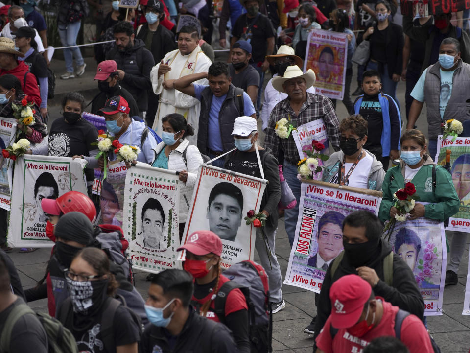 Relatives and classmates of the missing 43 Ayotzinapa college students march in Mexico City, Monday, Sept. 26, 2022, on the day of the anniversary of the disappearance of the students in Iguala, Guerrero in 2014. Three members of the military and a former federal attorney general were recently arrested in the case, and few now believe the government's initial claim that a local drug gang and allied local officials were wholly to blame for seizing and killing the students on July 26, 2014, most of which have never been found. (AP Photo/Marco Ugarte)