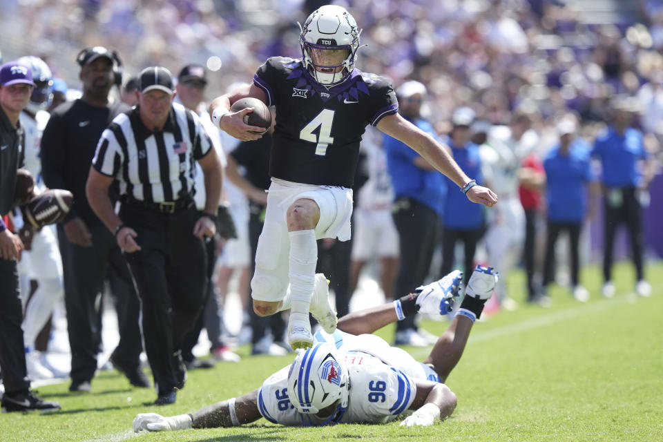 TCU quarterback Chandler Morris (4) jumps away from SMU defensive tackle DeVere Levelston (96) on a keeper player during the second half of an NCAA college football game Saturday, Sept. 23, 2023, in Fort Worth, Texas. (AP Photo/LM Otero)