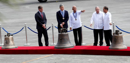 Philippine Defence Secretary Delfin Lorenzana and U.S. Ambassador to the Philippines Sung Kim lead a ceremony marking the return of the Balangiga bells, at Villamor Air Base in Pasay, Metro Manila, Philippines December 11, 2018. REUTERS/Erik De Castro