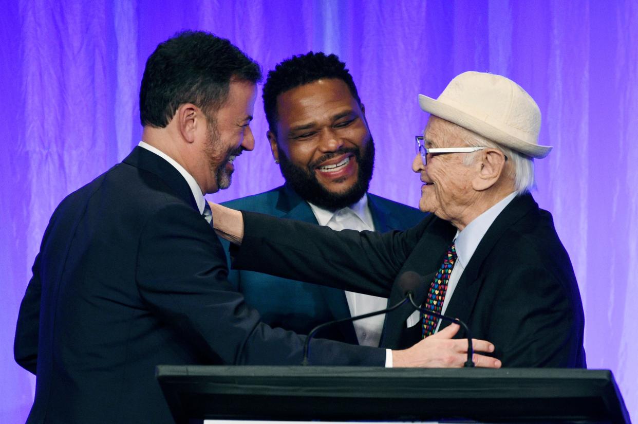 All-time producing great Norman Lear, right, embraces ABC late-night host Jimmy Kimmel, left, and 'Black-ish' star Anthony Anderson during a Paley Honors tribute to TV comedy legends.