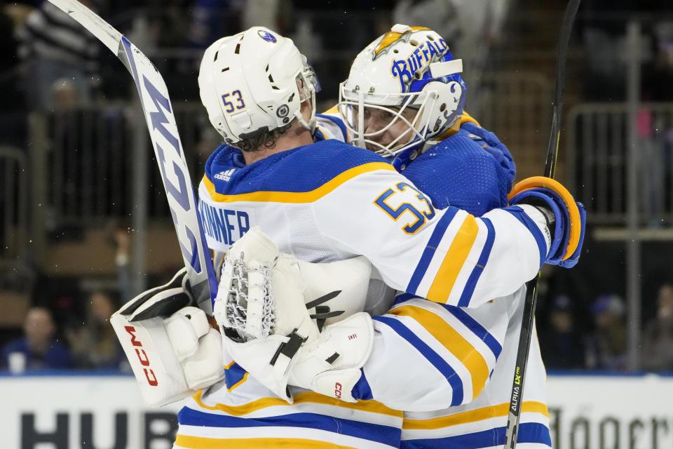 Buffalo Sabres goaltender Devon Levi, right, celebrates with left wing Jeff Skinner (53) after making the game-winning save against New York Rangers right wing Kaapo Kakko (24) during the overtime shootout period of an NHL hockey game, Monday, April 10, 2023, in New York. (AP Photo/John Minchillo)