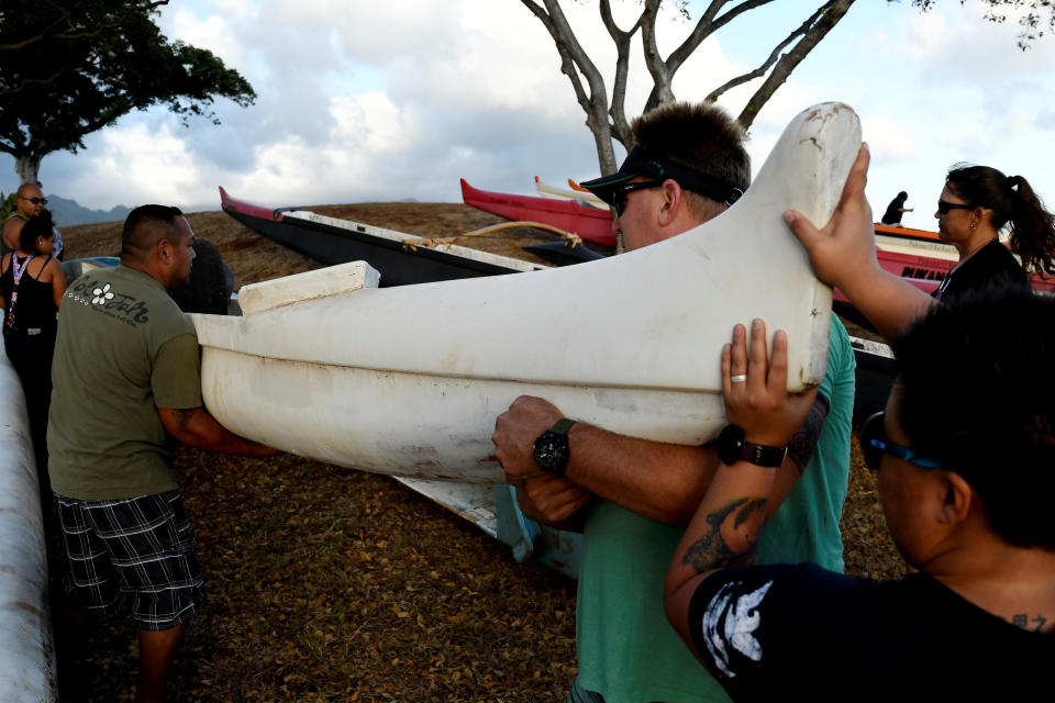 <p>Members of the Alapahoe outrigger canoe club move their canoes off the beach to higher ground as Hurricane Lane approaches Honolulu, Hawaii, Aug. 21, 2018. (Photo: Hugh Gentry/Reuters) </p>